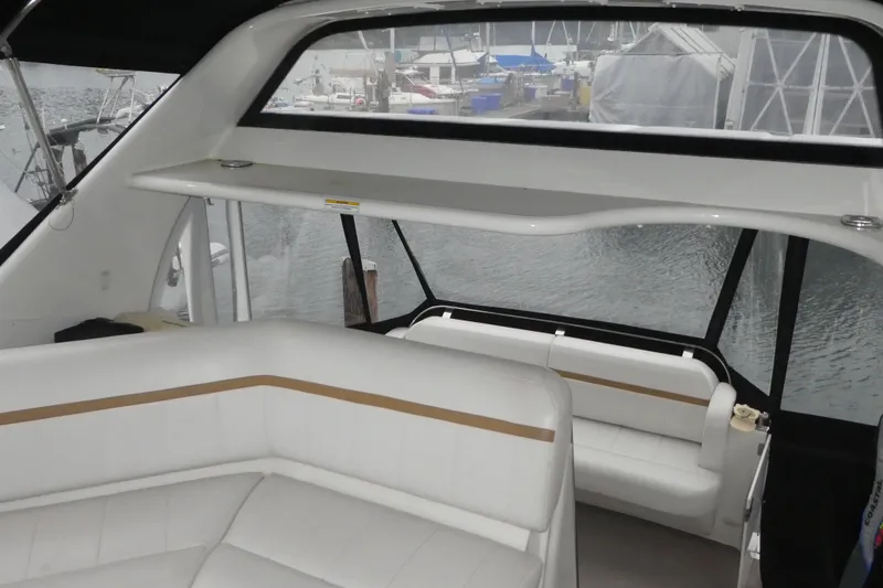 Slide: The Image of 2006 Carver 366 Motor Yacht interior with white seating and marina view. - 7