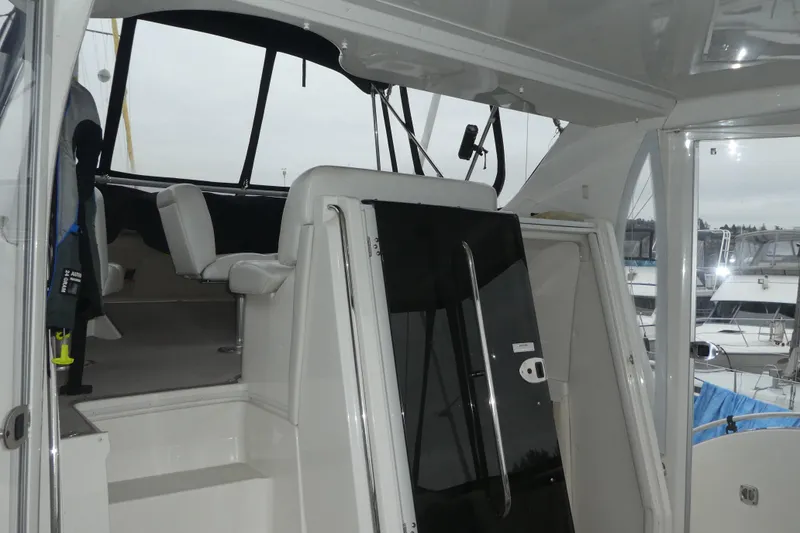 Slide: The Image of 2006 Carver 366 Motor Yacht interior with seating and helm, docked at marina. - 8