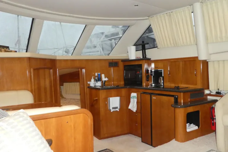 Slide: The Image of Interior of 2006 Carver 366 Motor Yacht with wooden cabinetry and modern amenities. - 16