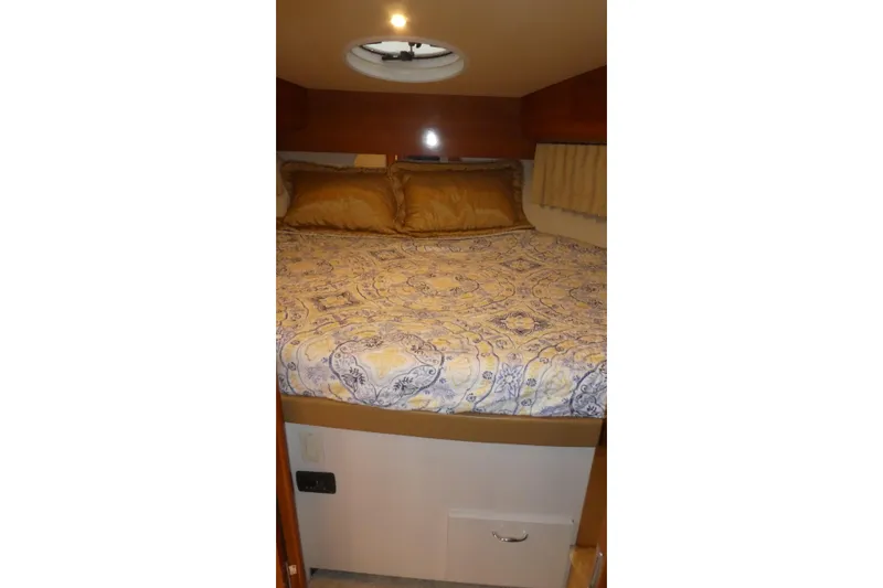 Slide: The Image of Cozy bedroom in 2006 Carver 366 Motor Yacht with patterned bedding and warm lighting. - 19