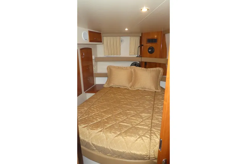 Slide: The Image of Interior cabin of 2006 Carver 366 Motor Yacht with cozy bed and wooden furnishings. - 26