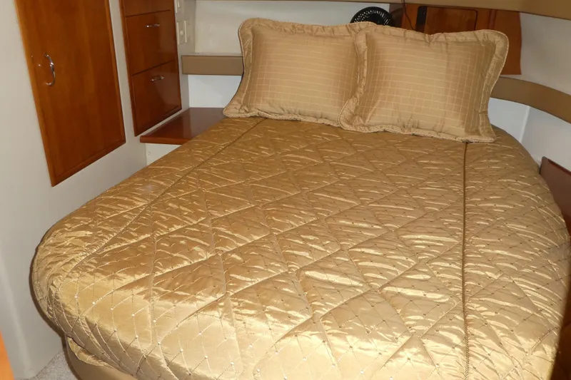 Slide: The Image of Luxurious bedroom interior of 2006 Carver 366 Motor Yacht with gold bedding. - 28