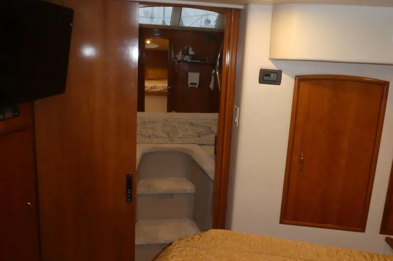 Slide: The Image of Interior of 2006 Carver 366 Motor Yacht with wood paneling and cozy cabin space. - 34