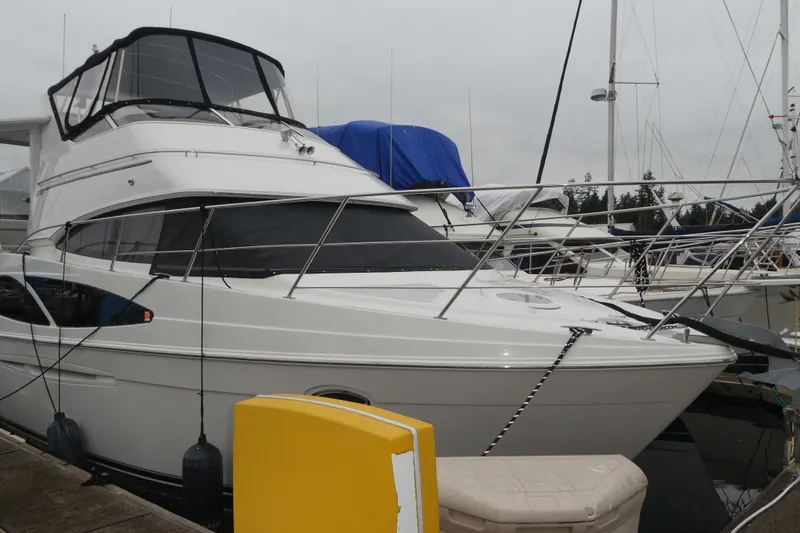 Slide: The Image of 2006 Carver 366 Motor Yacht docked at marina, featuring sleek design and spacious cabin. - 49