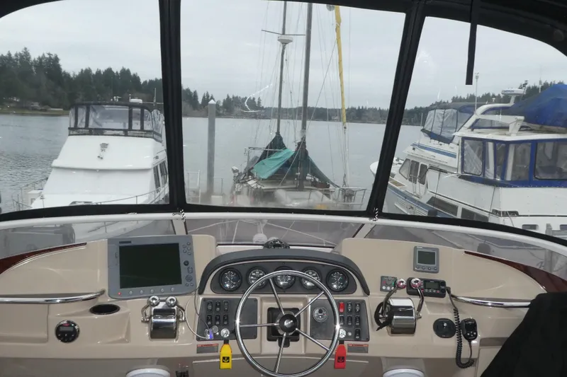 Slide: The Image of Helm of 2006 Carver 366 Motor Yacht with navigational equipment, docked in a marina. - 9