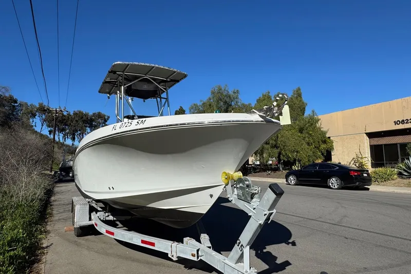 Slide: The Image of 2020 Wellcraft 222 Fisherman boat on trailer, parked on a sunny street. - 16