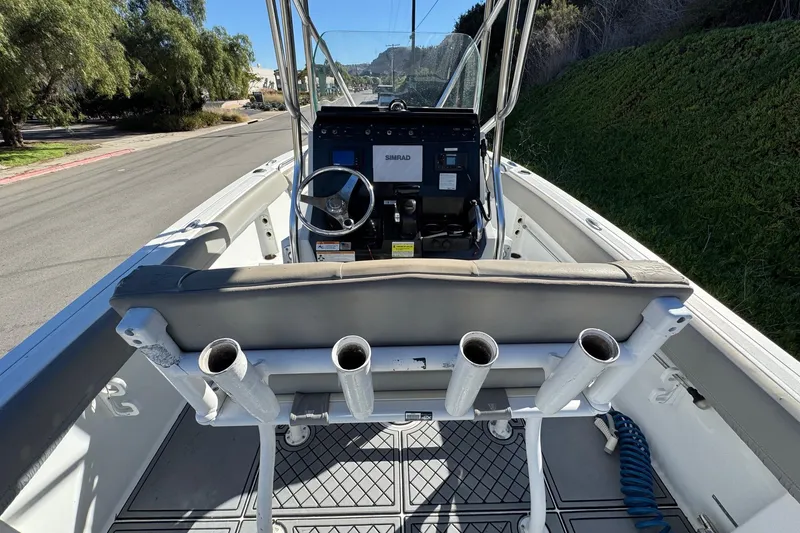 Slide: The Image of 2020 Wellcraft 222 Fisherman boat interior with steering console and rod holders. - 32