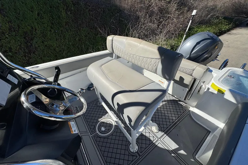 Slide: The Image of 2020 Wellcraft 222 Fisherman boat interior with steering wheel and seating. - 33