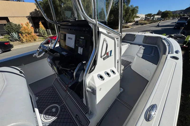 Slide: The Image of 2020 Wellcraft 222 Fisherman boat interior with steering console and seating area. - 41