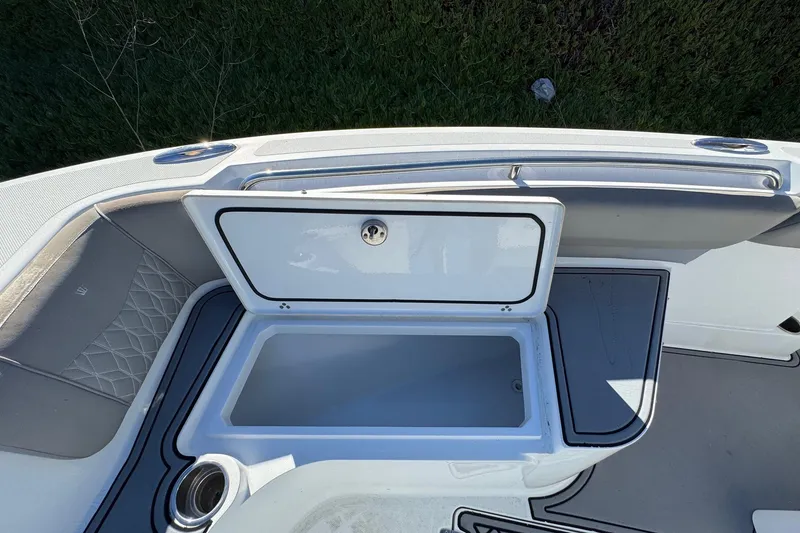 Slide: The Image of 2020 Wellcraft 222 Fisherman boat with open storage compartment and sleek interior design. - 52