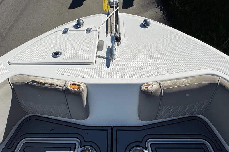 Slide: The Image of Bow view of 2020 Wellcraft 222 Fisherman boat with worn seating and anchor storage. - 54