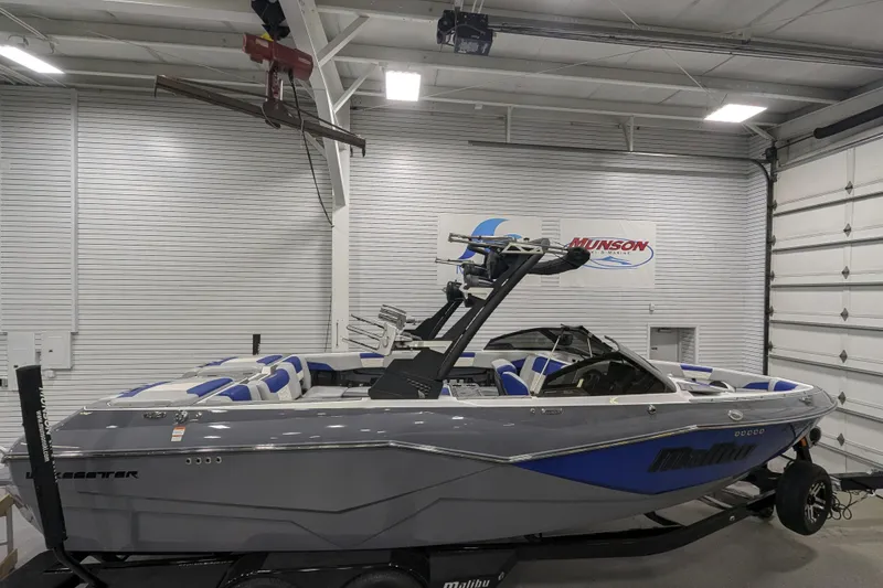 The Image of 2023 Malibu Wakesetter 25 LSV boat in showroom, gray and blue design. - 11
