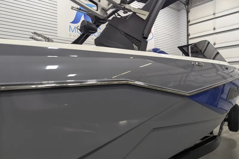 Slide: The Image of 2023 Malibu Wakesetter 25 LSV boat in showroom, sleek gray exterior design. - 13