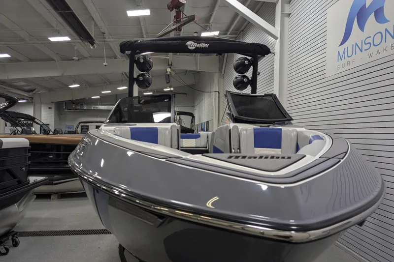Slide: The Image of 2023 Malibu Wakesetter 25 LSV boat in showroom, featuring sleek design and modern amenities. - 16