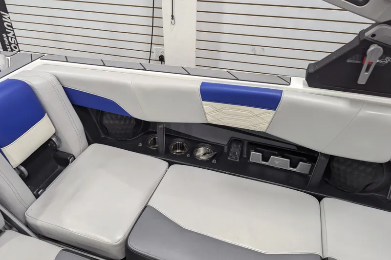 Slide: The Image of 2023 Malibu Wakesetter 25 LSV interior seating with blue and white upholstery. - 24