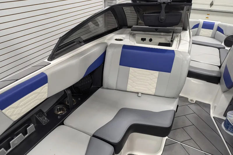 Slide: The Image of 2023 Malibu Wakesetter 25 LSV interior with blue and gray seating, modern design. - 26