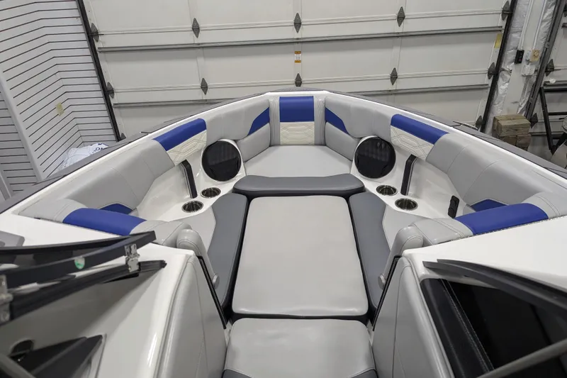 Slide: The Image of 2023 Malibu Wakesetter 25 LSV interior with blue and gray seating in a garage. - 28