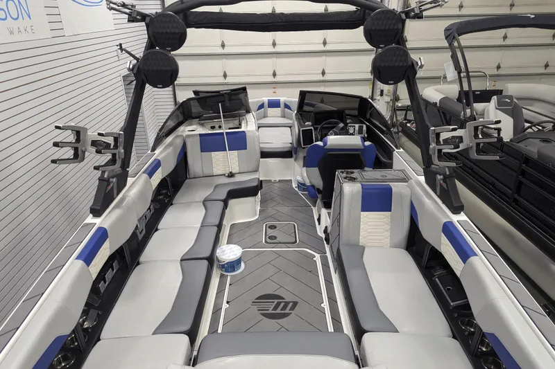 Slide: The Image of 2023 Malibu Wakesetter 25 LSV interior with blue and gray seating, advanced audio system. - 32