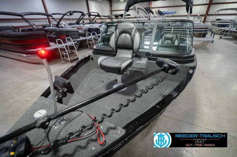 Slide: The Image of 2026 Lund 1675 Adventure Sport boat in showroom, featuring sleek design and modern seating. - 12