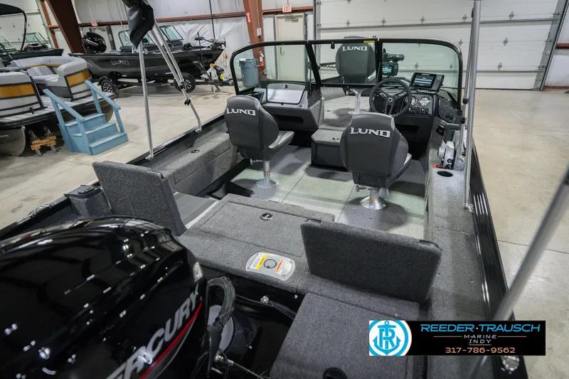 Slide: The Image of 2026 Lund 1675 Adventure Sport boat interior with Mercury engine in showroom. - 14