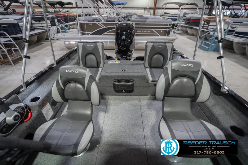 Slide: The Image of 2026 Lund 1675 Adventure Sport boat interior with gray seating in showroom. - 20