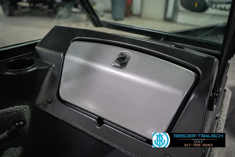 Slide: The Image of 2026 Lund 1675 Adventure Sport dashboard with glove compartment and cup holder. - 26