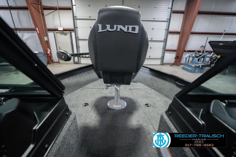 Slide: The Image of 2026 Lund 1675 Adventure Sport boat interior with branded seat in a garage setting. - 30