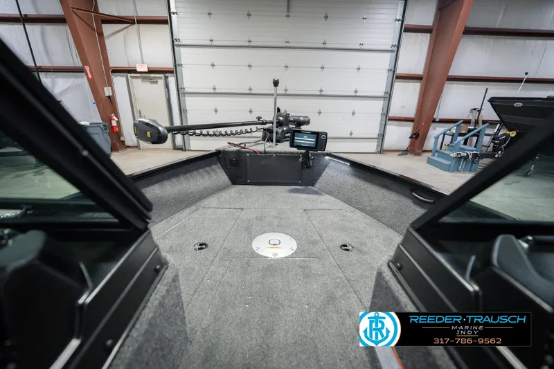 Slide: The Image of Interior view of 2026 Lund 1675 Adventure Sport boat in a garage setting. - 31