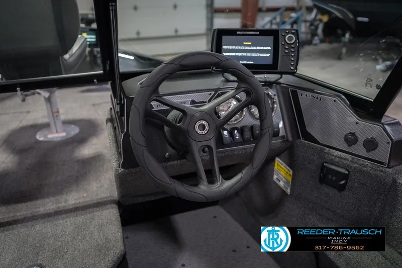 Slide: The Image of Interior view of 2026 Lund 1675 Adventure Sport boat with steering wheel and control panel. - 34