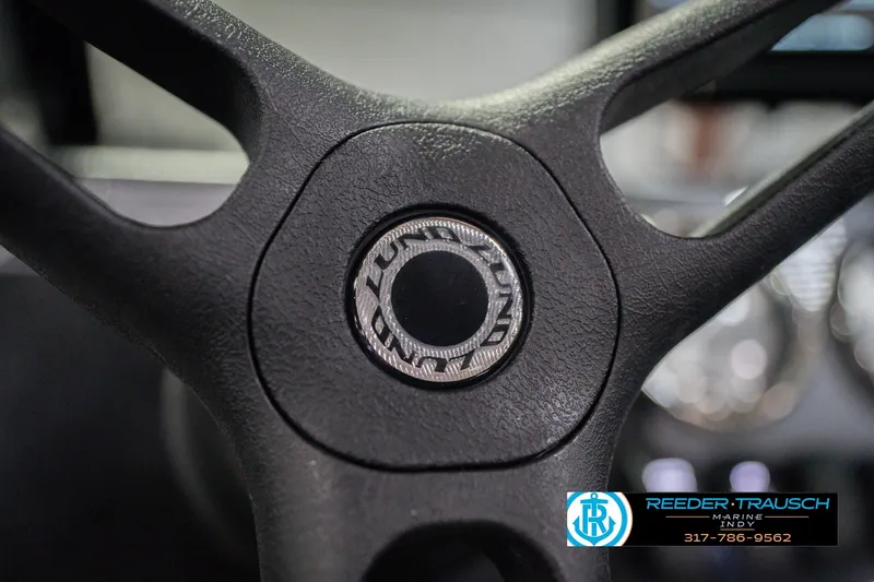 Slide: The Image of Steering wheel of 2026 Lund 1675 Adventure Sport boat, featuring logo detail. - 35