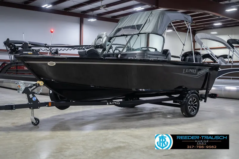 Slide: The Image of 2026 Lund 1675 Adventure Sport boat in showroom with trailer and canopy. - 4