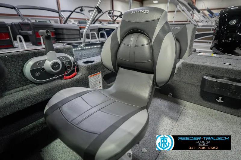 Slide: The Image of 2026 Lund 1675 Adventure Sport boat interior with comfortable seating and control panel. - 40