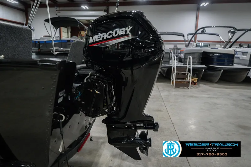 Slide: The Image of 2026 Lund 1675 Adventure Sport with Mercury outboard motor in showroom. - 47