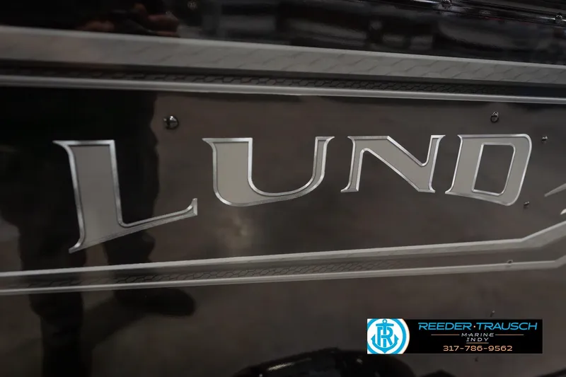 Slide: The Image of Close-up of 2026 Lund 1675 Adventure Sport boat logo with dealership contact. - 56