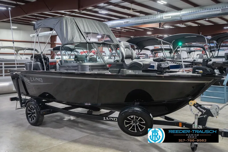 Slide: The Image of 2026 Lund 1675 Adventure Sport boat displayed indoors on a trailer. - 6