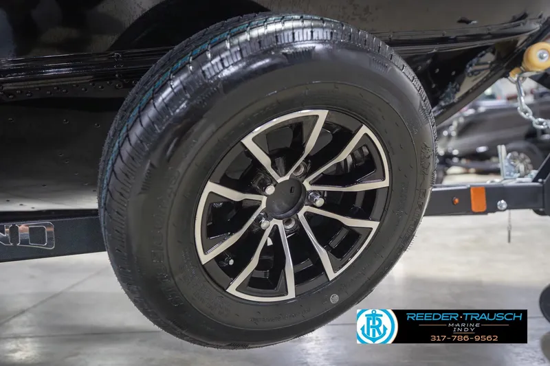 Slide: The Image of 2026 Lund 1675 Adventure Sport trailer wheel with sleek black and silver design. - 67