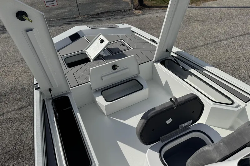 Slide: The Image of 2026 Avid 21 Recon ST boat interior with open storage compartments and sleek design. - 10