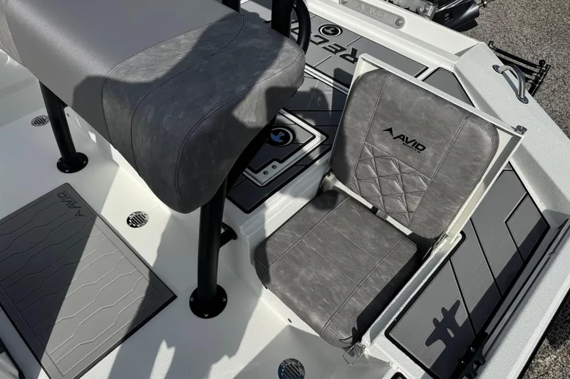 Slide: The Image of 2026 Avid 21 Recon ST boat interior with gray seating and branded flooring. - 13