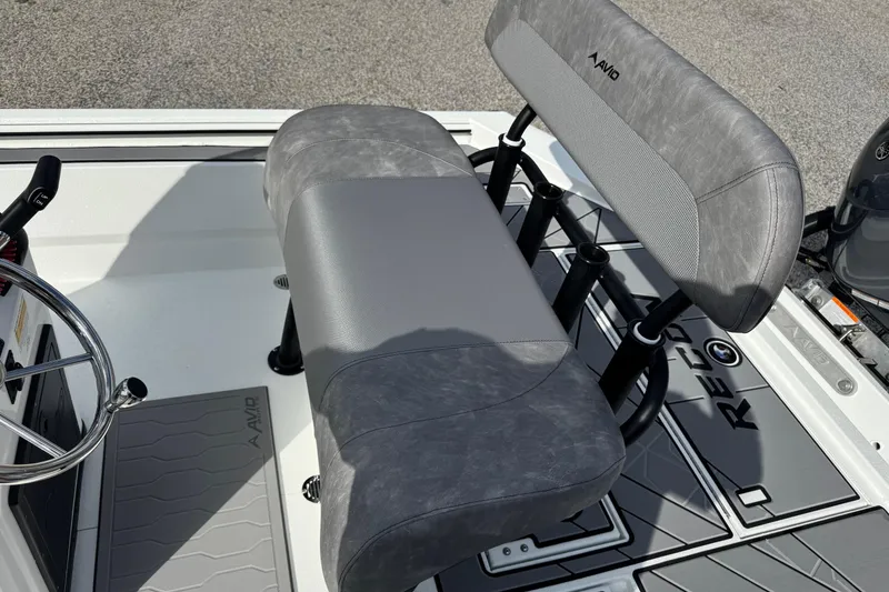 Slide: The Image of 2026 Avid 21 Recon ST boat interior with gray seating and steering wheel. - 15