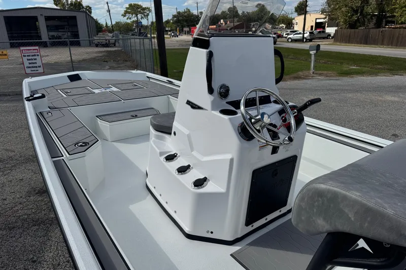 Slide: The Image of 2026 Avid 21 Recon ST boat with sleek console and steering wheel, parked outdoors. - 9