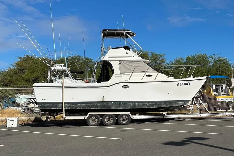 Slide: The Image of 2007 Baha Cruisers 340 King Cat boat on trailer in parking lot. - 10
