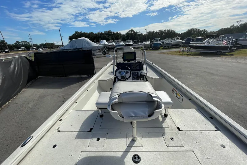 Slide: The Image of 2023 Ranger RB190 boat interior with console, parked in a marina under a partly cloudy sky. - 13