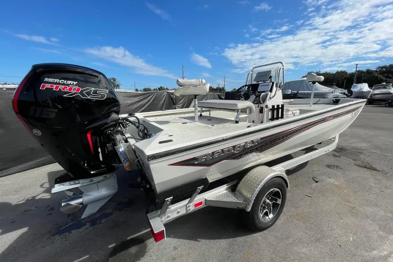 Slide: The Image of 2023 Ranger RB190 boat with Mercury Pro XS engine on trailer under blue sky. - 2