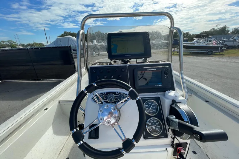 Slide: The Image of 2023 Ranger RB190 boat dashboard with steering wheel, gauges, and navigation screens. - 21