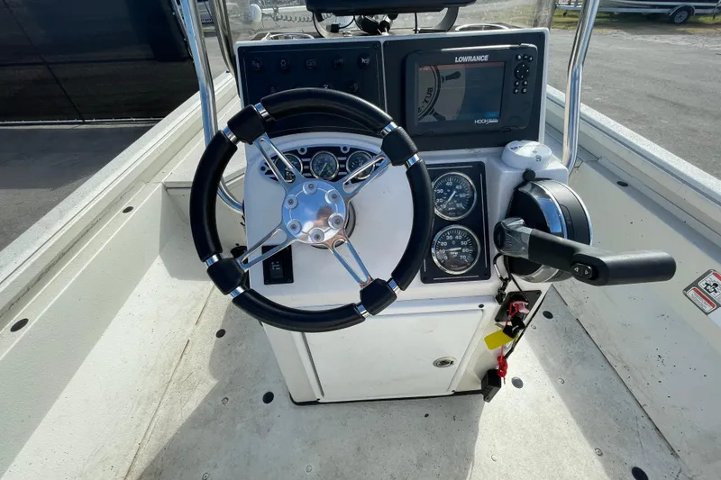 Slide: The Image of 2023 Ranger RB190 boat console with steering wheel, gauges, and Lowrance display. - 23