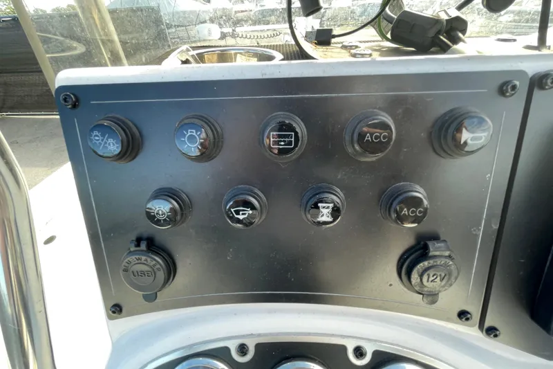 Slide: The Image of Control panel of 2023 Ranger RB190 boat with various switches and USB port. - 25