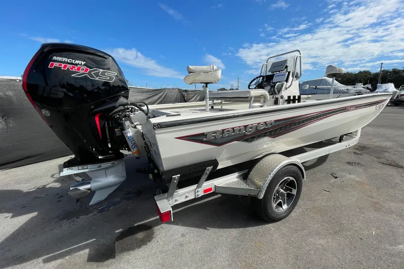 Slide: The Image of 2023 Ranger RB190 boat with Mercury Pro XS engine on trailer, under clear blue sky. - 3