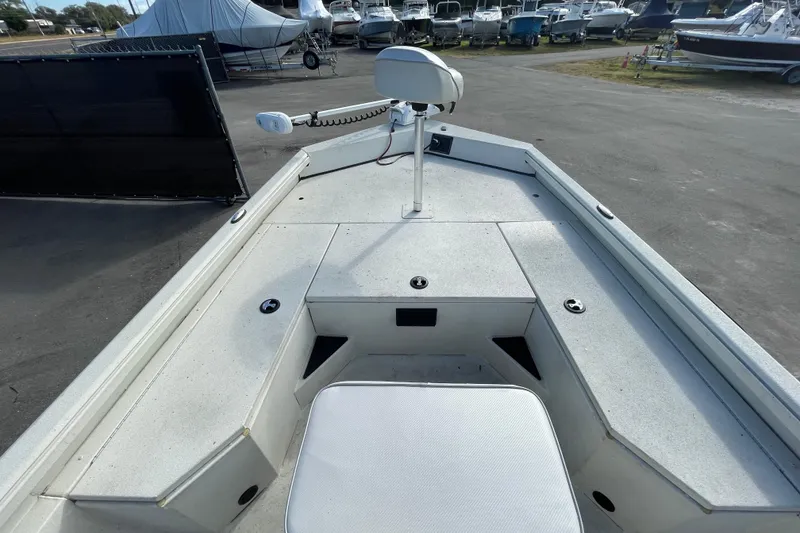 Slide: The Image of 2023 Ranger RB190 boat deck with seating and trolling motor in a marina setting. - 30
