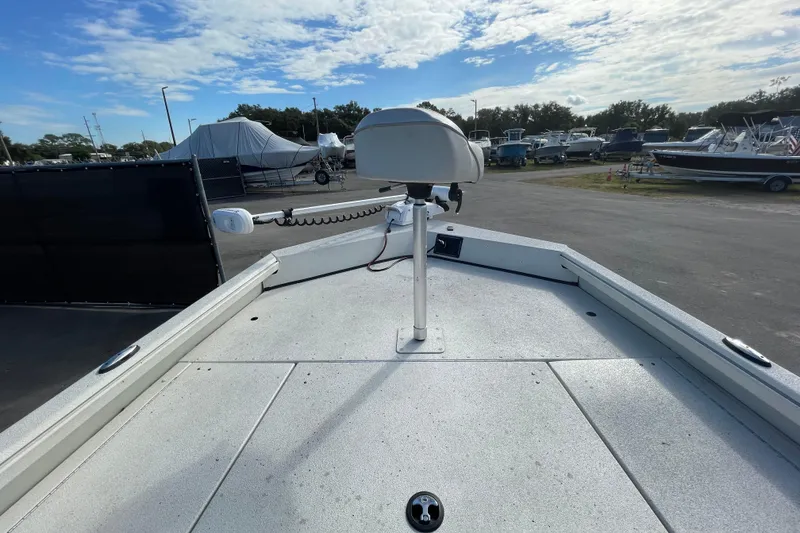 Slide: The Image of 2023 Ranger RB190 boat deck with mounted equipment, parked in a marina under a cloudy sky. - 33