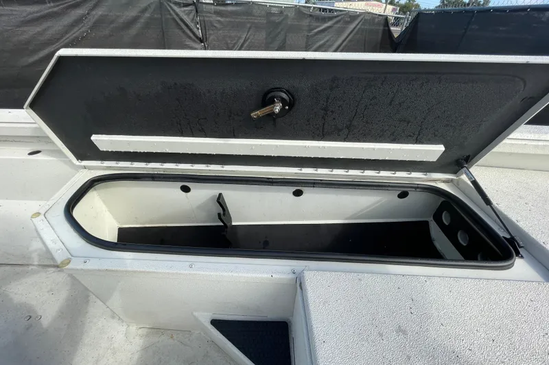 Slide: The Image of Open storage compartment on 2023 Ranger RB190 boat, showing interior space. - 36